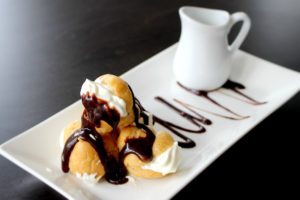 Dining at Parade House in Monmouth - Profiteroles as light as air, topped with chocolate and filled with cream.