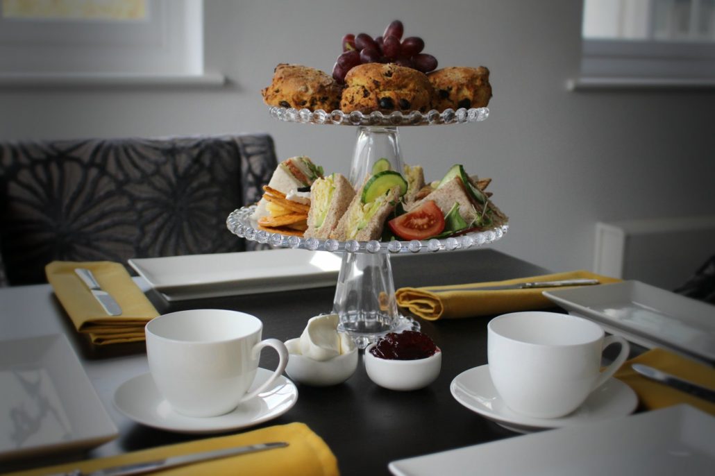 Dining at Parade House in Monmouth - Afternoon Tea is a meal composed of sandwiches (cut delicately into small triangles), scones with clotted cream and jam, sweet pastries and cakes.