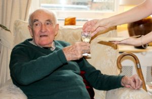 Resident enjoying a glass of wine at Parade House in Monmouth