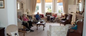 Residents relaxing in the comfortable lounge area at Parade House in Monmouth